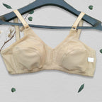 Beige bra on a hanger with a light background