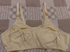Beige bra on a patterned fabric background