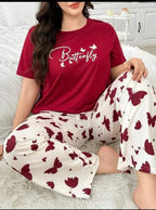Person wearing a red 'Butterfly' t-shirt and white pants with red butterfly patterns on a white couch.