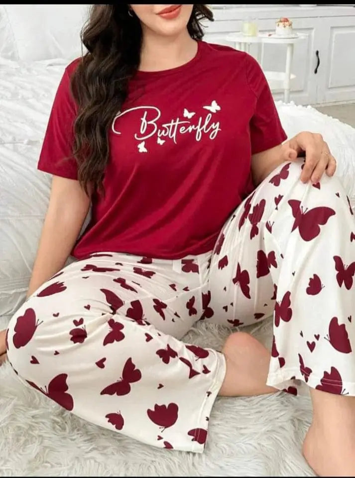Person wearing a red 'Butterfly' t-shirt and white pants with red butterfly patterns on a white couch.