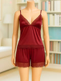 A two-piece lingerie set in deep burgundy red displayed on a mannequin. The set includes a camisole top with thin straps and lace trim at the bust, and matching lace-trimmed shorts.